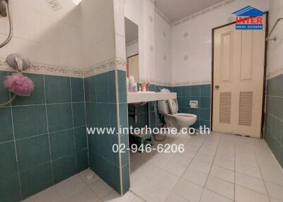 Spacious bathroom with blue tiles and modern fixtures