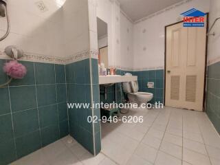 Spacious bathroom with blue tiles and modern fixtures