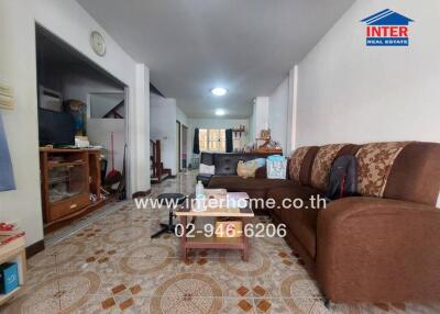 Spacious living room with tiled flooring and ample seating