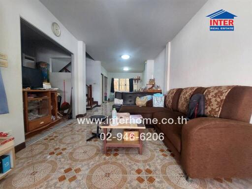 Spacious living room with tiled flooring and ample seating