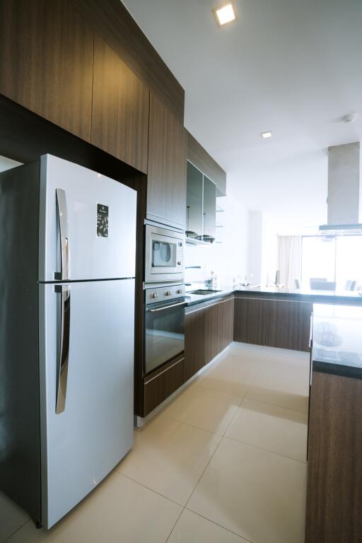 Modern kitchen with built-in appliances and ample lighting