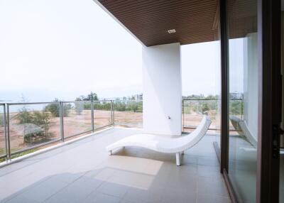 Spacious balcony with a scenic view and modern lounge chair
