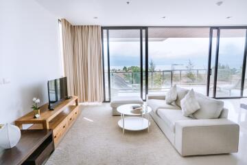 Spacious and modern living room with large windows and scenic views
