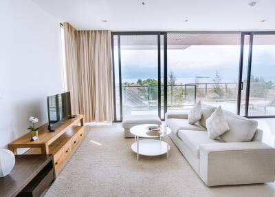 Spacious and modern living room with large windows and scenic views