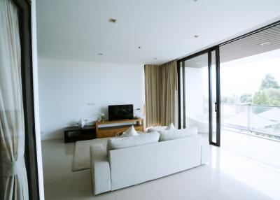 Spacious modern living room with large windows and ample natural light