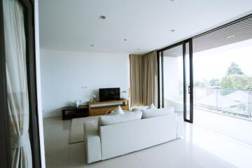 Spacious modern living room with large windows and ample natural light