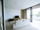 Spacious modern living room with large windows and ample natural light