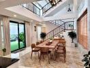 Spacious dining room with modern staircase and open layout leading to a patio