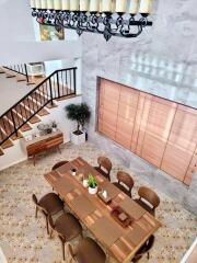Elegant dining area with staircase and stylish wooden decor