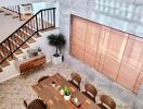 Elegant dining area with staircase and stylish wooden decor