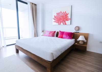 Bright and inviting bedroom with wooden bed frame and modern decor