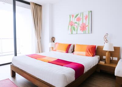 Bright and colorful bedroom with large window and modern decor