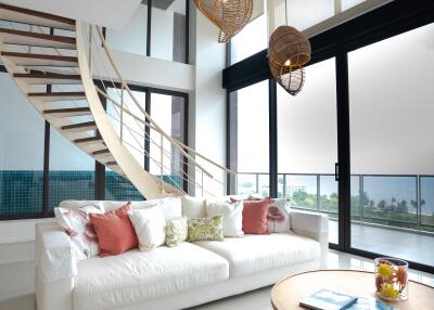 Elegant living room with modern staircase and high ceiling