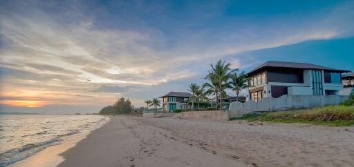 Beachfront houses at sunset with clear skies