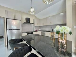 Modern kitchen with elegant black granite countertops and fully equipped appliances