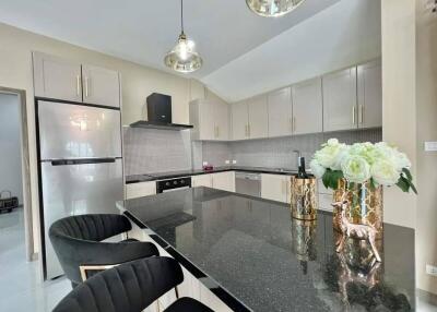 Modern kitchen with elegant black granite countertops and fully equipped appliances