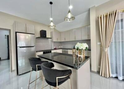 Modern kitchen with stainless steel appliances and elegant furnishings