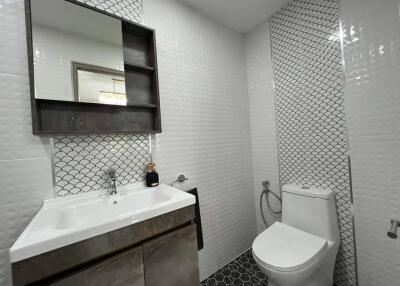Modern bathroom with stylish tiling and fixtures