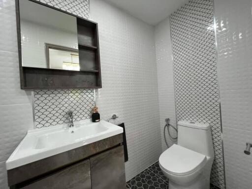 Modern bathroom with stylish tiling and fixtures