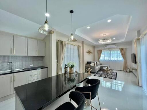 Modern kitchen with integrated dining area and elegant decor