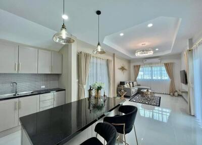 Modern kitchen with integrated dining area and elegant decor