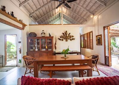 Spacious tropical style living room with high ceilings and natural light