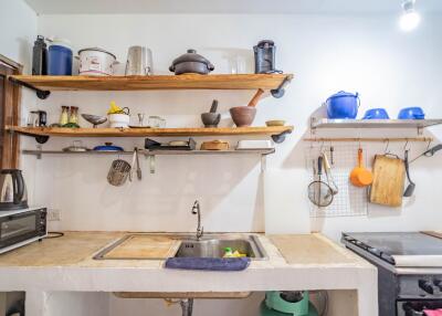 cozy rustic style kitchen with wooden shelves and assorted utensils