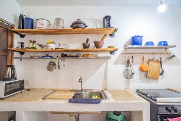 cozy rustic style kitchen with wooden shelves and assorted utensils