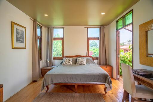 Spacious bedroom with large windows and natural light