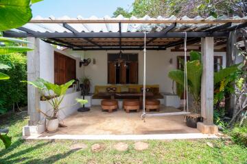 Cozy outdoor patio with comfortable seating and lush greenery