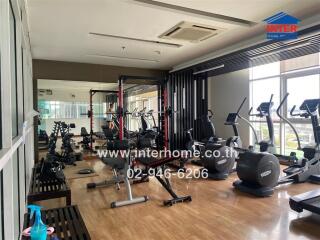 Spacious indoor gym with modern equipment and large windows