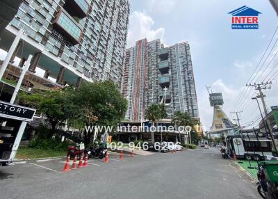 Exterior view of modern apartment buildings with commercial spaces and busy street scene