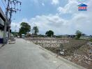 Empty lot with road access and clear sky