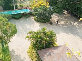 Aerial view of well-maintained courtyard with paved paths and lush greenery