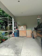 Spacious garage area with parked car and storage space