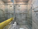 Modern bathroom with marble finishes and glass shower enclosure