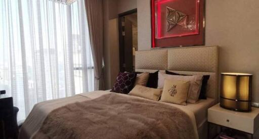 Elegant and cozy bedroom with a plush bed, chic decor, and ample natural light