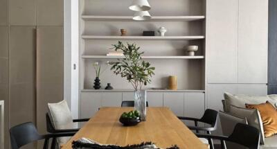 Stylish modern dining room with natural wood table and elegant decor