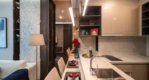 Modern kitchen with integrated dining space featuring marble counter tops and elegant cabinetry