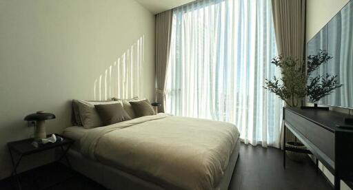 Modern bedroom with natural light and elegant decor