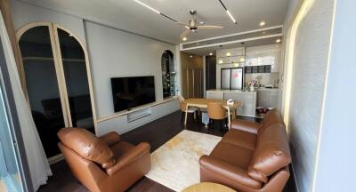 Elegant living room with kitchen in the background