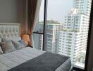 Elegant bedroom with a large window providing a cityscape view