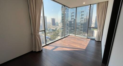 Spacious bedroom with large windows and city view