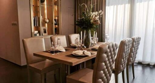 Elegantly decorated dining room with a modern wooden table and plush chairs