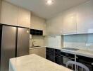 Modern kitchen with white cabinetry and marble countertop