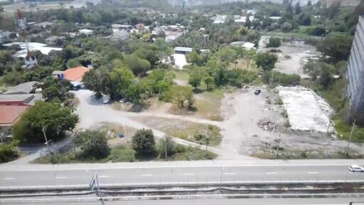 Aerial view from building showing surrounding area with road and greenery