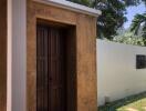Elegant exterior view of a house showing a stylish wooden door and stucco walls