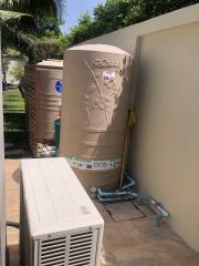 Outdoor utility area with storage tank and air conditioning unit