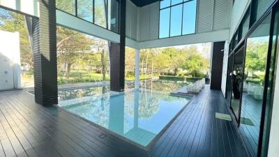 Modern living space with large glass windows and an indoor pool