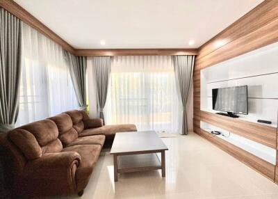 Spacious and modern living room with wooden accents and large sofa